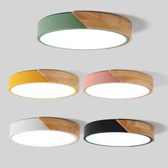 four circular lights with different colors and shapes hanging from the ceiling, on top of each other