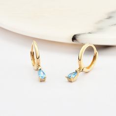 ➤MATERIALS ABOUT EARRINGS Material: 14K Gold, Real Gold. We don't use plated gold or filled gold in our products. Gold Karat: 14 Karat Gold (585). Necklace Colours: 14K Yellow Gold, 14K Rose Gold, 14K White Gold. Gemstone: Aquamarine  Charm Height: 5.5 mm (0.22 inch)  without ring on top -7 mm with ring on top (0.28 inch)  Charm Width: 3 mm (0.12 inch) ★INFORMATION ABOUT EARRINGS Handmade with 14 karat real gold. You can order this earrings with 3 different colour options free express shipping t Elegant Aquamarine Drop Earrings, Handmade Gold Aquamarine Earrings, Elegant Round Aquamarine Earrings, Gold Aquamarine Gemstone Earrings, Elegant Aquamarine Nickel-free Earrings, Aquamarine Earrings, Aquamarine Stone, Gold Hoop, March Birth Stone