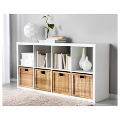 a white bookcase with wicker baskets on top