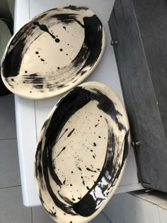 two black and white plates sitting on top of a counter