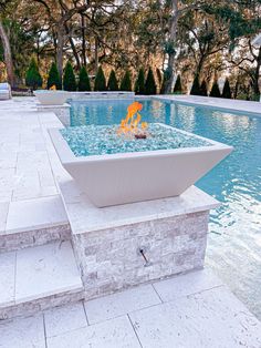 an outdoor fire pit in the middle of a swimming pool