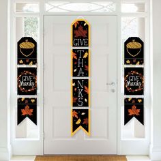 two thanksgiving banners hanging on the front door to give thanks and thanks for someone who has passed this year