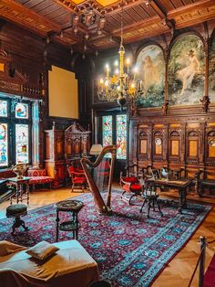 a harp sits in the middle of a large room with ornate paintings on the walls