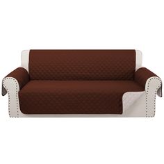 a couch covered in brown and white furniture