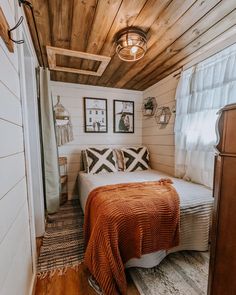 a bed sitting in the middle of a bedroom next to a window