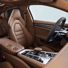 the interior of a luxury car with brown leather