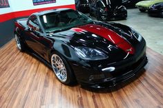 a black sports car parked in a showroom