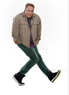 a man in green pants and a plaid shirt is walking with his hands in his pockets