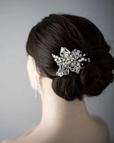 a close up of a woman's head wearing a hair comb with pearls on it