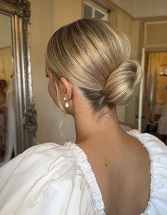 a woman with blonde hair in a white dress