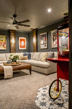 a living room filled with furniture and pictures on the wall