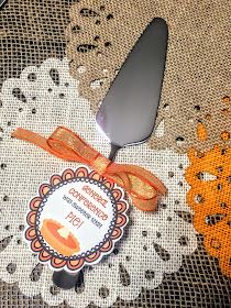 an orange ribbon is tied around a knife on a doily with a label that says,