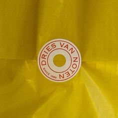 there is a yellow plastic bag with a white circle on the bottom and red lettering