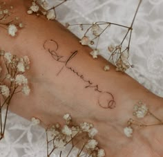 a woman's arm with the word love written in cursive writing on it