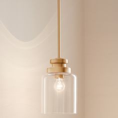 a light fixture hanging from the ceiling in a room with white walls and flooring