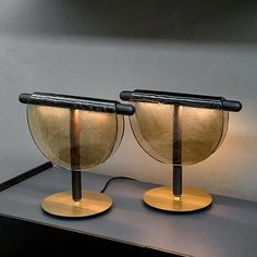 two lamps sitting on top of a table next to each other