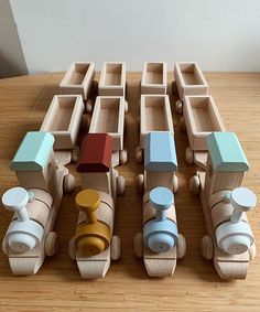 a wooden toy train set on top of a wooden table next to other wood toys