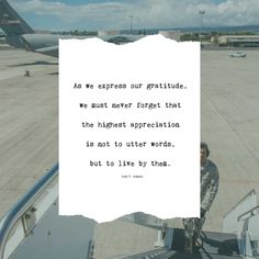 a man standing on top of an airport tarmac holding a piece of paper in his hand