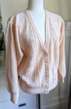 Vintage wool and angora cardigan in beautiful blush pink. Beaded on the front and sleeves with pearl colored beads. Ruched shoulders, slightly puffy sleeves.Super soft and feminine. Best fits S/M. Made by Marisa Christina Classics, Hong Kong. In excellent vintage condition with no visible flaws. Measurements laying flat in inches: shoulder to shoulder 18 bust 19.5 waist 17.5 hips 15 (ribbed) shoulder to hip 24 shoulder to cuff 22 Vintage Pink Outfits, Cardigan Pink, Soft Pink Cardigan, Elegant Pink Winter Cardigan, Cute Pink Winter Cardigan, Ae Outfits, Pink Vintage Spring Sweater, Elegant Pink V-neck Cardigan, Elegant Pink V-neck Sweater