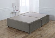 two mattresses sitting on top of each other in a room with hardwood floors and white walls