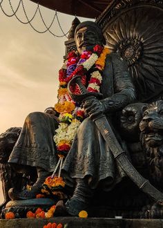 a statue of a man sitting on top of a lion