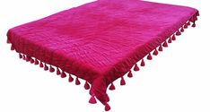 a pink table cloth with tassels on it