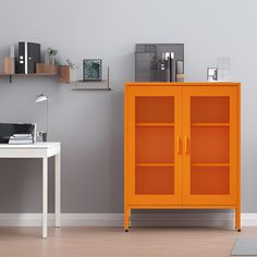 an orange cabinet sitting next to a white desk