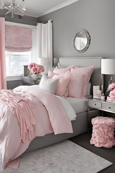 a bedroom with pink and gray decor in shades of grey, white, and pink