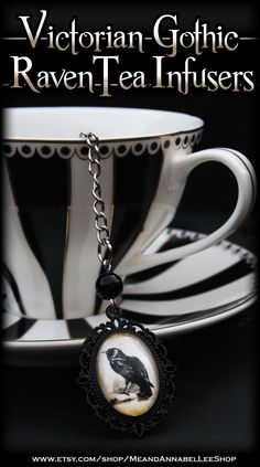 a cup and saucer with a black crow on it, sitting next to the words victorian gothic raven - tea infusers