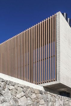 a stone wall with wooden slats on it