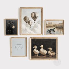 four framed pictures with animals and hot air balloons in them, all hanging on the wall