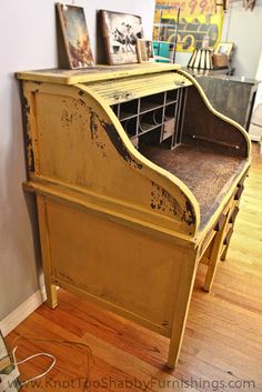 an old yellow piano sitting on top of a hard wood floor