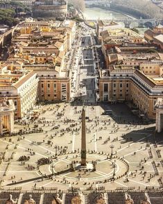 an aerial view of a city with lots of buildings and people walking in the streets