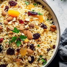 a bowl filled with rice, nuts and dried cranberries