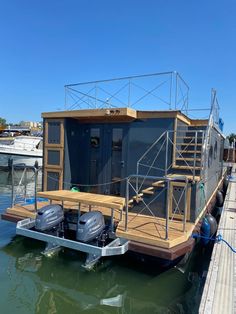 a houseboat is docked on the water with its stairs up to it's roof