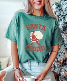 Get into the festive spirit with this Christmas T-shirt featuring a fun 'Santa Squad' design. Made with high-quality, garment-dyed fabric for a soft color and texture, this Comfort Colors 1717 tee is perfect for spreading holiday cheer. Available in sizes S to 4XL, this unisex T-shirt is ideal for men and women looking to add a touch of Christmas joy to their wardrobe. Product features - Available in sizes S to 4XL for a perfect fit - Double-needle stitching for durability - Made with garment-dy Holiday Cotton T-shirt Pre-shrunk, Relaxed Fit Crew Neck T-shirt For Christmas, Red Christmas T-shirt With Relaxed Fit, White Relaxed Fit Christmas T-shirt, Relaxed Fit Christmas T-shirt For Holiday, Top Christmas Gifts, Christmas Tops, Xmas Shirts, Christmas Santa