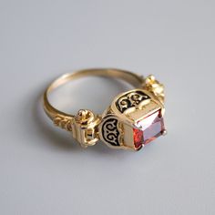 Renaissance ring with enamel and cubic zirconia stone.  This design was popular in 16th century Western Europe and you can find it in many portraits of that age as well as in museums. Our luxurious vintage ring can perfectly complete your Renaissance dress and become an eye-catcher on any medieval event. Each ring cast from Italian brass, plated with 24k gold and hand painted with black enamel. Gemstone is cubic zirconia, available colors: red, white (transparent), green, blue. Please choose your size and stone color. This ring is pretty massive and sometimes may appear a little bit oversize, so if you're hesitating between two sizes, we recommend you to choose a smaller one. Please note: gold plated rings are not intended for constant wearing. Please take your ring off while taking a show Heirloom Engraved Ring With Historical Design As Gift, Heirloom Engraved Ring With Historical Design, Heirloom Engraved Ring With Historical Design For Gifts, Heirloom Historical Design Engraved Ring As Gift, Victorian Rings With Historical Design For Ceremonial Occasion, Antique Jewelry Ring With Historical Design, Victorian Gold Jewelry With Stone Setting, Antique Rings With Historical Design For Gift, Medieval Style Wedding Jewelry