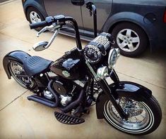 a black motorcycle parked next to a car