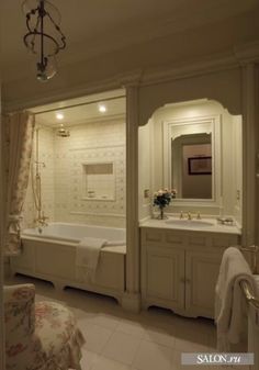 a large bathroom with a tub, sink and mirror in the middle of it's walls