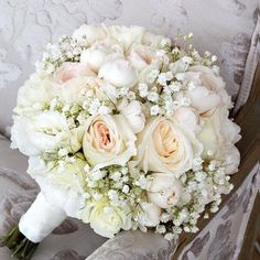 a bridal bouquet sitting on top of a chair