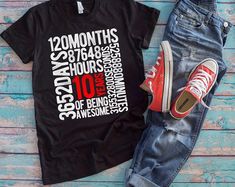 a t - shirt with the words 25 years on it next to jeans and sneakers