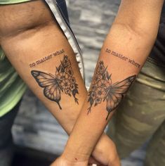 two people holding hands with butterfly tattoos on their arms and the words no matter what