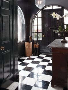 a black and white checkered floor with an arched window in the center is shown