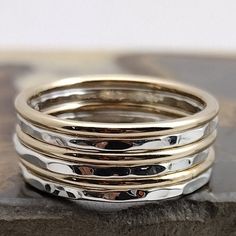 This Smooth Gold & Hammered Sterling stacking ring set is entirely hand-made & mixes well with most of the items in our store. * This listing is for one 6-band set: 3 Hammered Sterling bands & 3 Polished Gold-filled bands. * Made with: 16g (1.29 mm) 12k Yellow Gold-filled & Sterling Silver wire. * When stacked, they measure at about 7 rings per half inch. * All of our items are entirely hand crafted and have a standard processing time of 3-5 Business days to make the order. * Items are processed Stacked Round Rings As Gift, Stacked Round Rings For Anniversary, Stack Rings, Sweet Jewelry, Beaded Jewels, Stacking Ring Set, Stack Ring, Gold And Silver Rings, Solid Gold Earrings