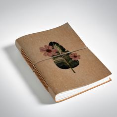 a brown book with pink flowers on it