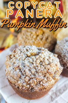 two pumpkin muffins sitting on top of a white plate with the title copycat panera pumpkin muffin