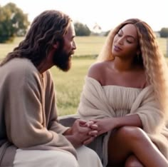 a man and woman sitting next to each other in front of a grass covered field