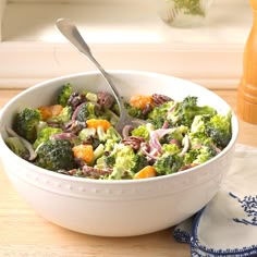 a white bowl filled with broccoli and other vegetables