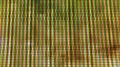 an old television screen with green and yellow lines in the background, as seen from above