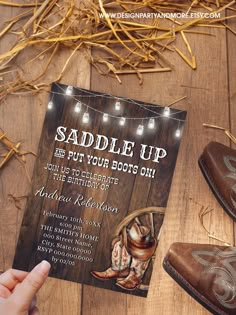 a cowboy themed birthday party with boots and string lights on the wood floor next to it